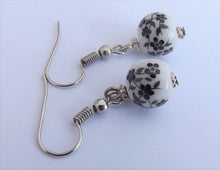 Load image into Gallery viewer, Small Black Flowers on White, Ceramic Look Bead Earrings