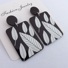 Load image into Gallery viewer, White Leaves on Black Acrylic Rectangle Earrings
