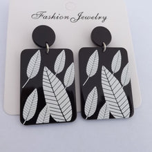 Load image into Gallery viewer, White Leaves on Black Acrylic Rectangle Earrings
