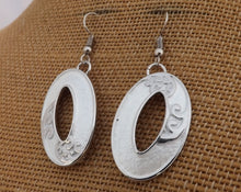 Load image into Gallery viewer, Frosted White &amp; Silver Tone Hollowed Oval Drop Earrings with Ponga Frond Detail
